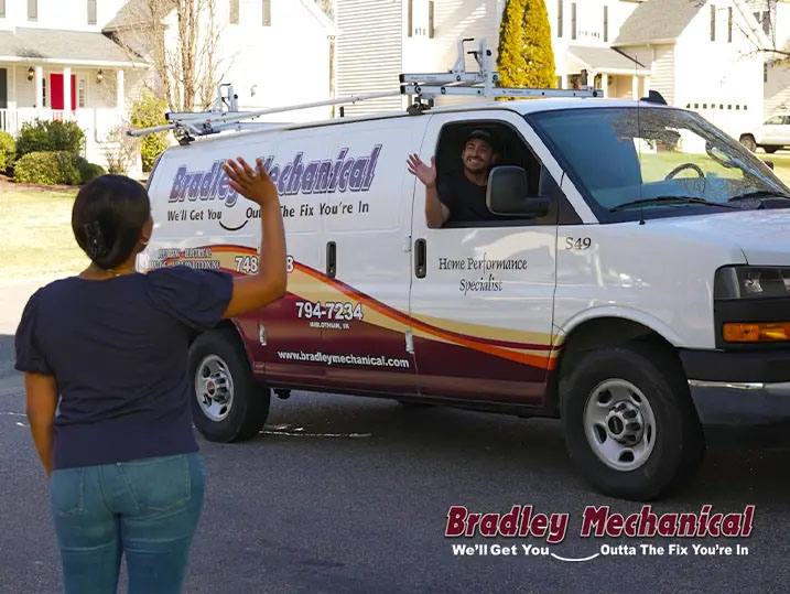 Customer waving to a Bradley Mechanical employee sitting in a company van